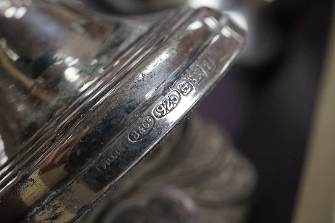 Two silver mounted hand mirrors including Reynold's Angels, Chester, 1899, 26.7cm, together with four silver mounted dressing table implements, a pair of silver mounted dwarf candlesticks and four assorted silver mounted